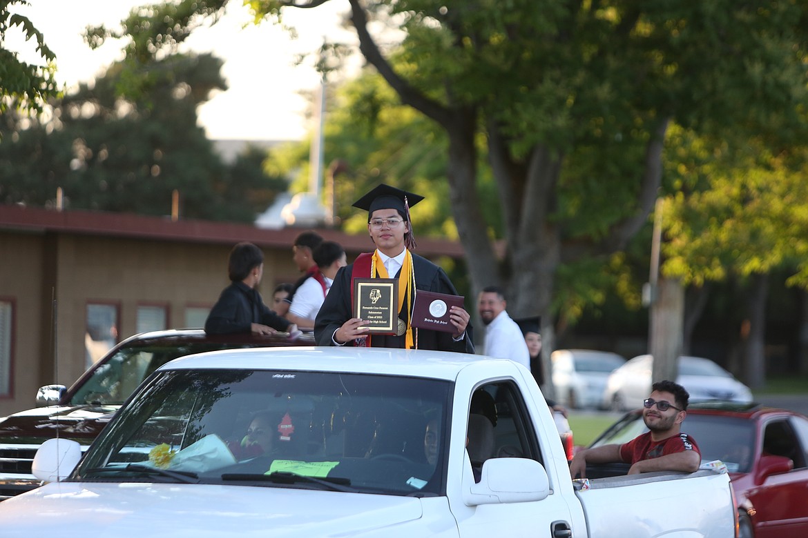 Wahluke’s Class of 2023 Salutatorian Fernando Pazaran smiles during the graduation parade down the streets of Mattawa. The new Warrior alumni rode down Road S SW inside and on top of decorated pick-up trucks and SUVs, with some graduates riding on horses and on top of a backhoe.