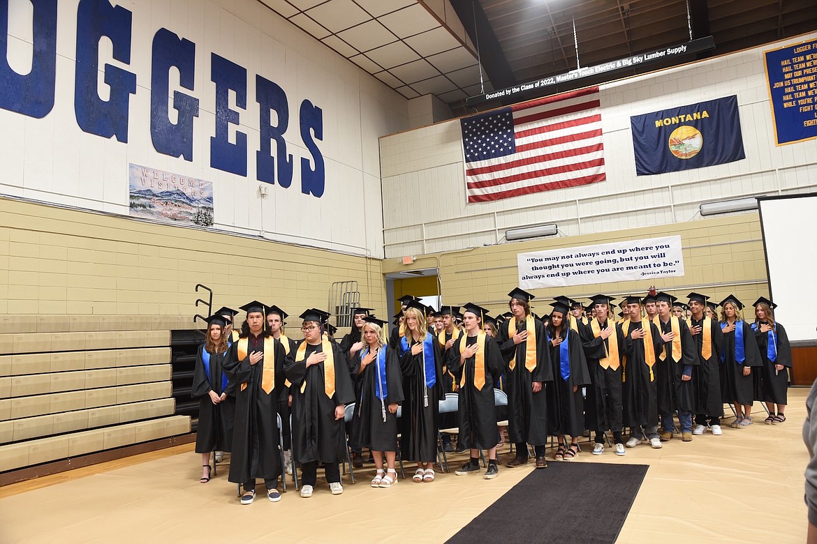 The 2023 Libby High School graduating class stands for the playing of the nation anthem during ceremonies on Saturday, June 3, in Ralph Tate Gymnasium. (Scott Shindledecker/The Western News)