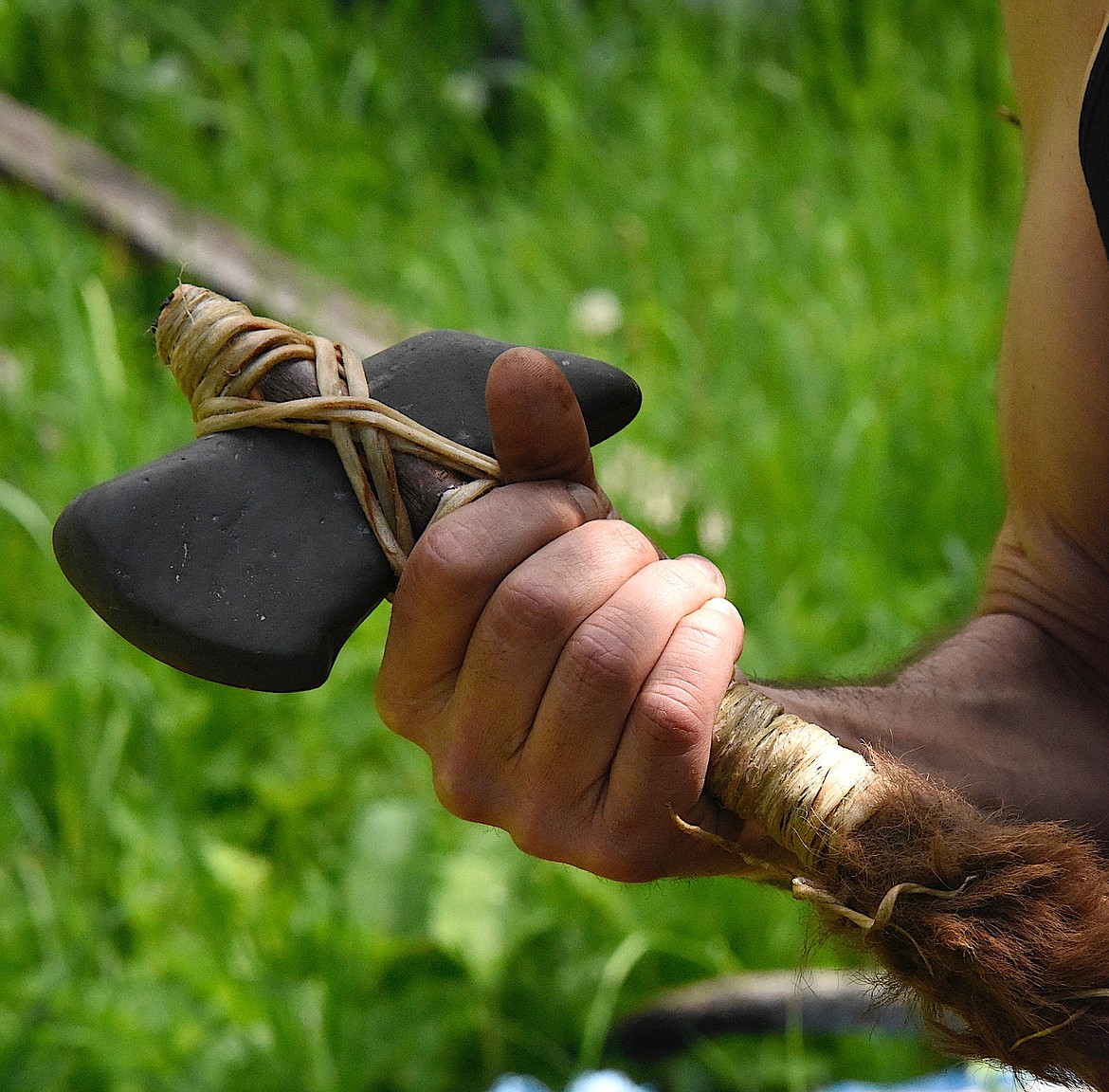 Native traditionalist Buck Hitswithastick chose and shaped the stone with other stones, scraped and cut the rawhide, and picked just the right handle for this axe. (Berl Tiskus/Leader)