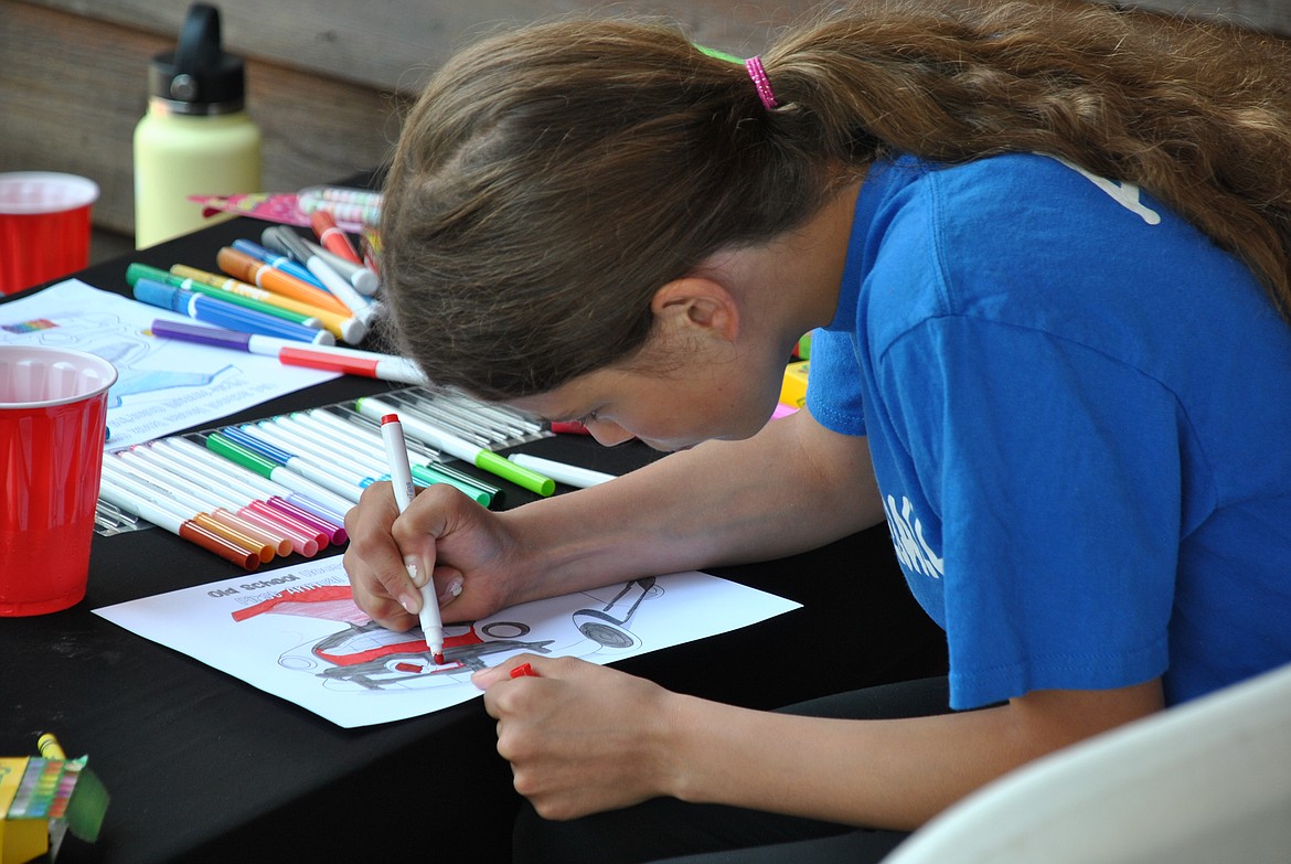 At the kids games and activities zone during the car show, children were encouraged to complete a coloring page for a chance to win some awesome prizes. (Mineral Independent/Amy Quinlivan)