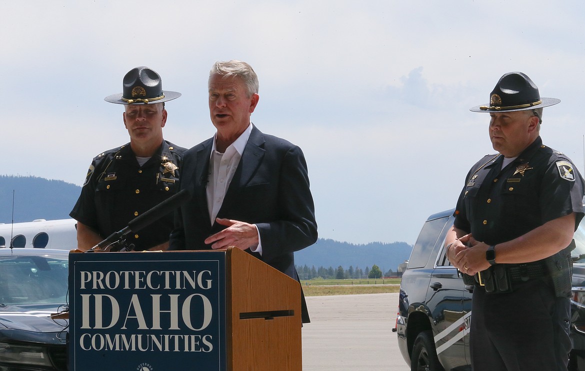 Idaho Gov. Brad Little on Monday, center, gives a press conference at the StanCraft Jet Center in Hayden to discuss Idaho State Police troopers working to fight the fentanyl smuggling crisis at the Texas-Mexico border. Also pictured: ISP Capt. John Kempf, left and ISP Col. Kedrick Wills.