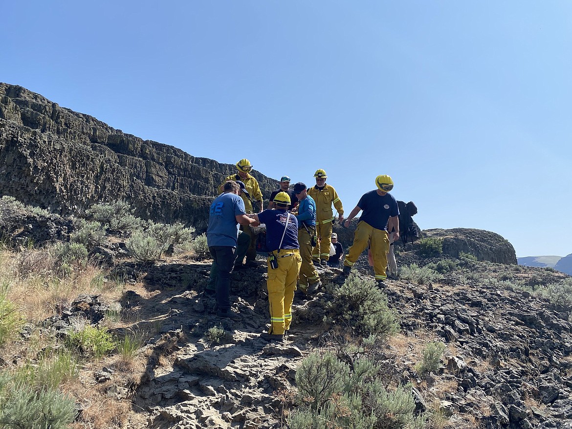 Rescuers from Grant County fire districts 17 and 13 extricate a hiker who fell and was injured at the Lenore Caves Friday.