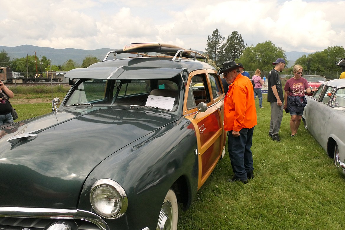 A vintage car fan gets an up-close look at a 1951 Ford Country Squire "woody" during the Rehbein For Car Show, part of Saturday's annual Plains Day party. (Chuck Bandel/VP-MI)