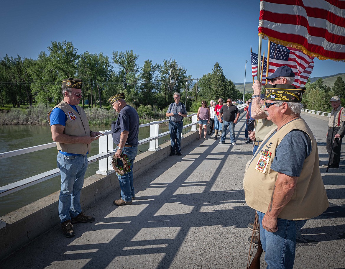 Members of the Wild Horse Plains VFW prepare to release a ceremonial wreath into the waters of the Clark Fork River in honor of the area's many Navy veterans during a Memorial Day ceremony last week in Plains. (Tracy Scott/Valley Press)