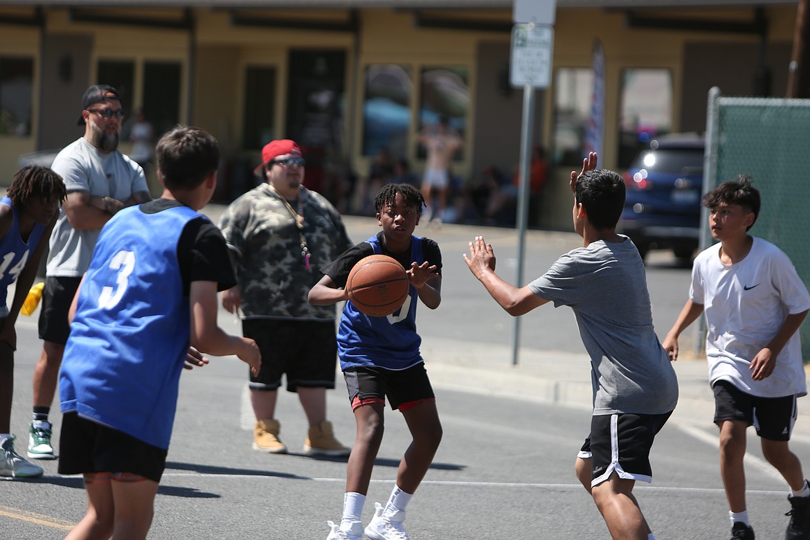 A player finds an open teammate for a pass during the Dru Gimlin 3-on-3 basketball tournament.