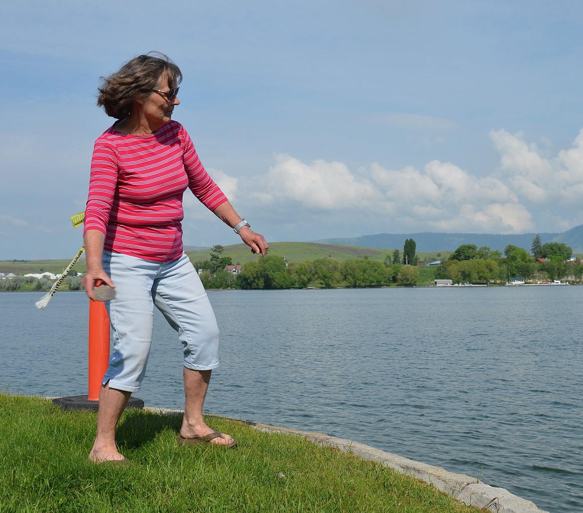 Veteran rock skipper Pat DeVries prepares to launch another smooth stone across the Flathead River Saturday. Her toss earned her top honors in the women's category during World Championship Rock-Skipping Championship, besting previous champ Katie Walter, who came in second. (Kristi Niemeyer/Leader)