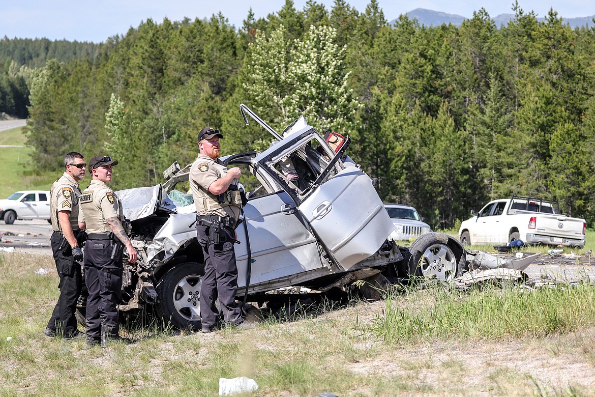 Law enforcement officials access the scene of a fatal multi-vehicle collision on U.S. 2 near Coram on Monday. (JP Edge/Hungry Horse News)