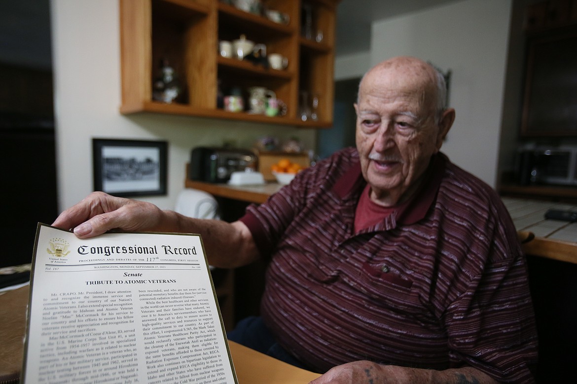 Atomic veteran Mac McCormack, 86, on Tuesday holds up a Congressional Record tribute to atomic veterans including information about his service at a nuclear test site in the 1950s.