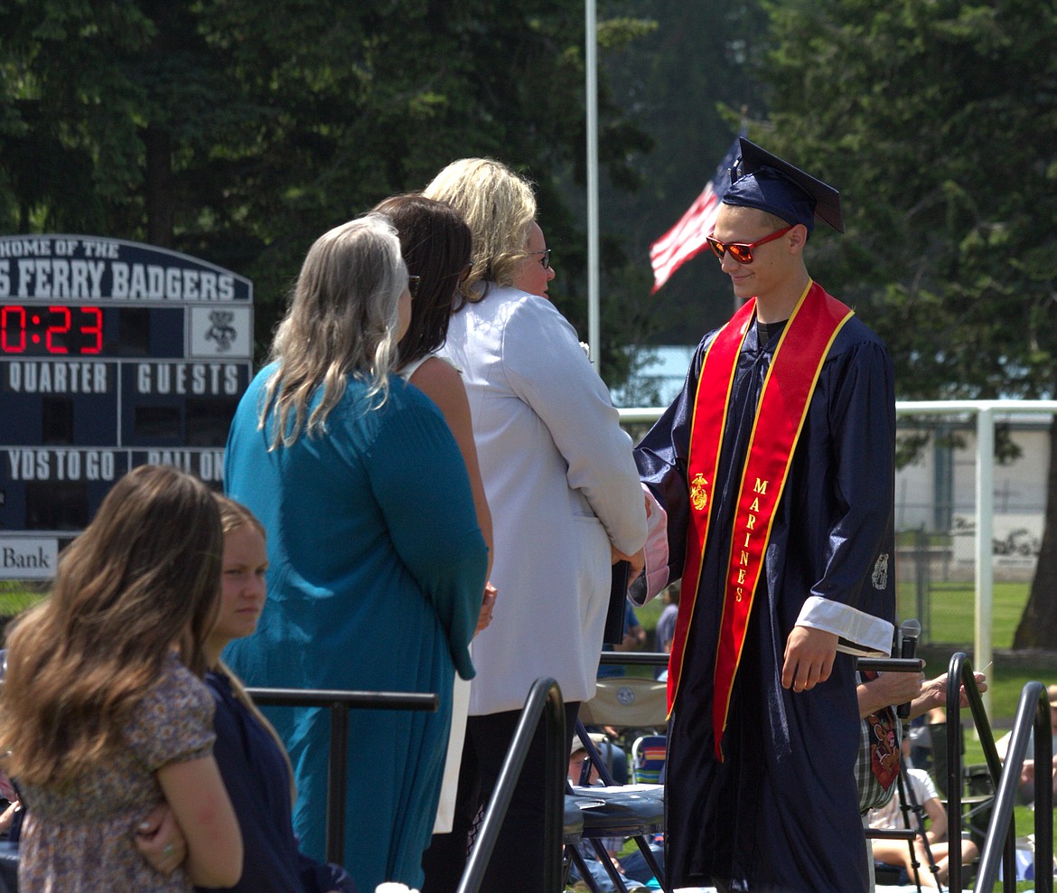 Travis Atkins receives diploma, he is to serve in the U.S. Marine Corps.