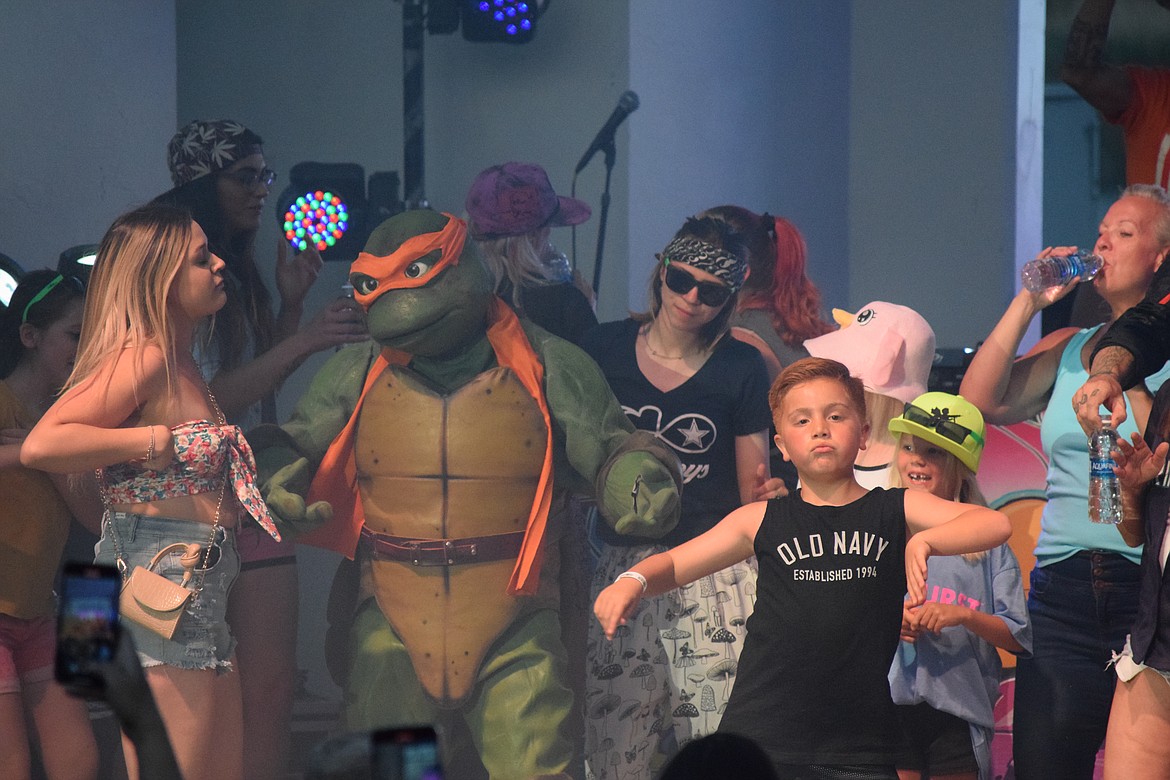 Max House dances onstage with area residents, Vanilla Ice and a Teenage Mutant Ninja Turtle on May 28 at McCosh Park in Moses Lake.