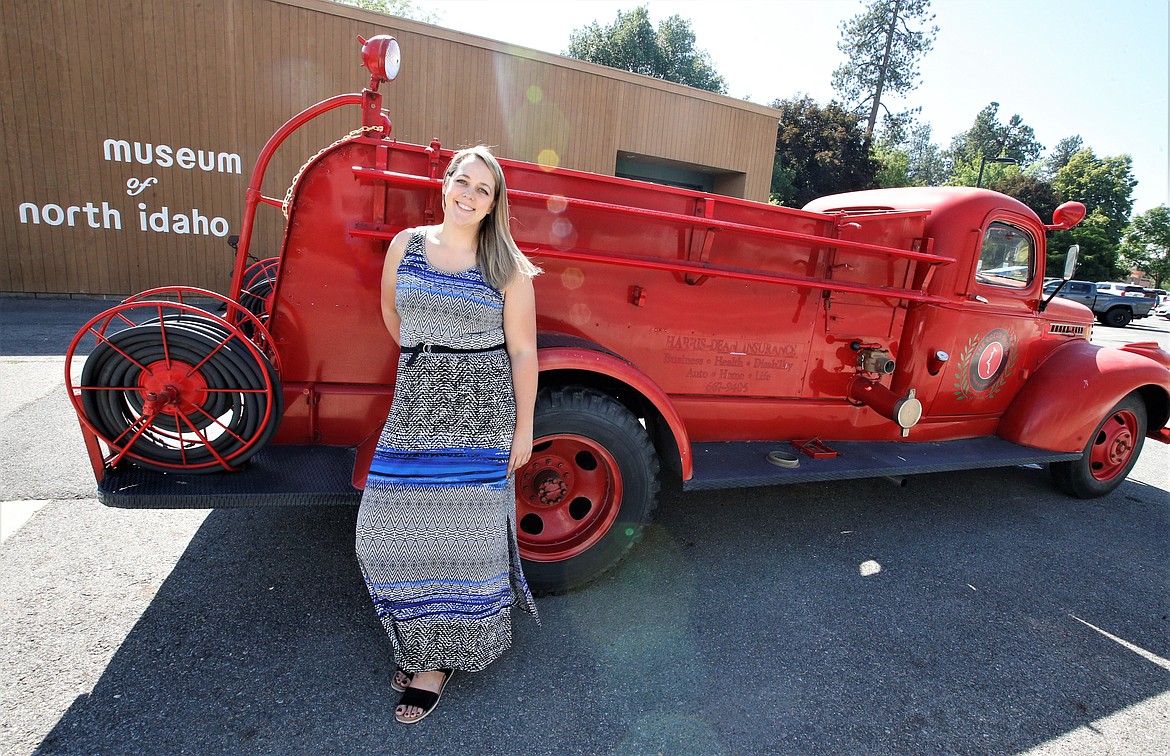 Museum of North Idaho Executive Director Britt Thurman stands by the 1943  fire truck that was used at Farragut Naval Training Base in World War II. The Coeur Group donated the fire truck to the museum.