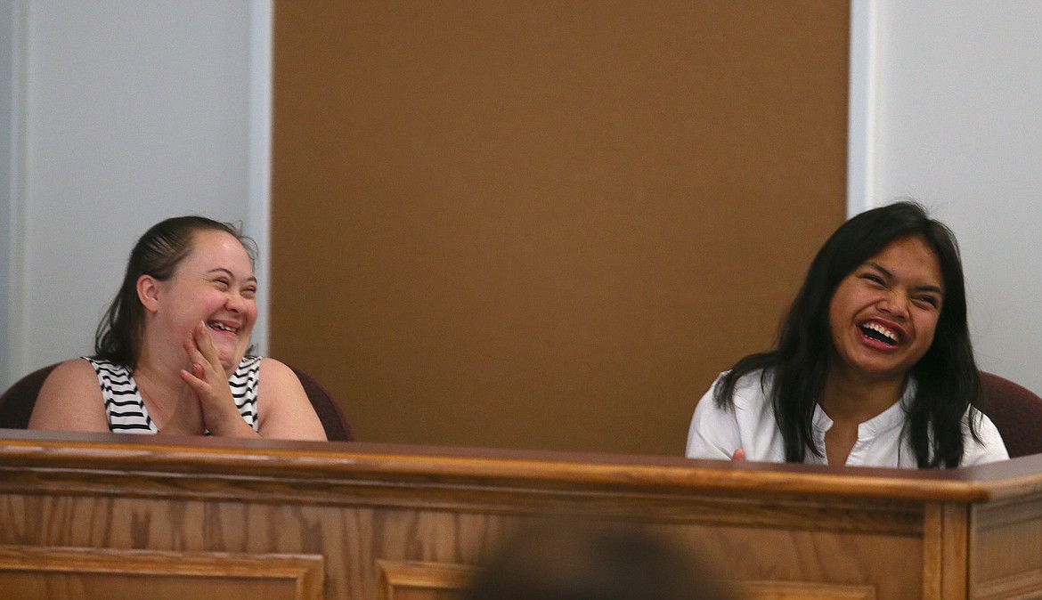 Lori Ann Macklin, left, and Miriam Northrup share a happy moment as a speaker discusses Northrup's nickname at work for her speed, "The Flash," Wednesday evening during the 2023 Project SEARCH graduation ceremony.