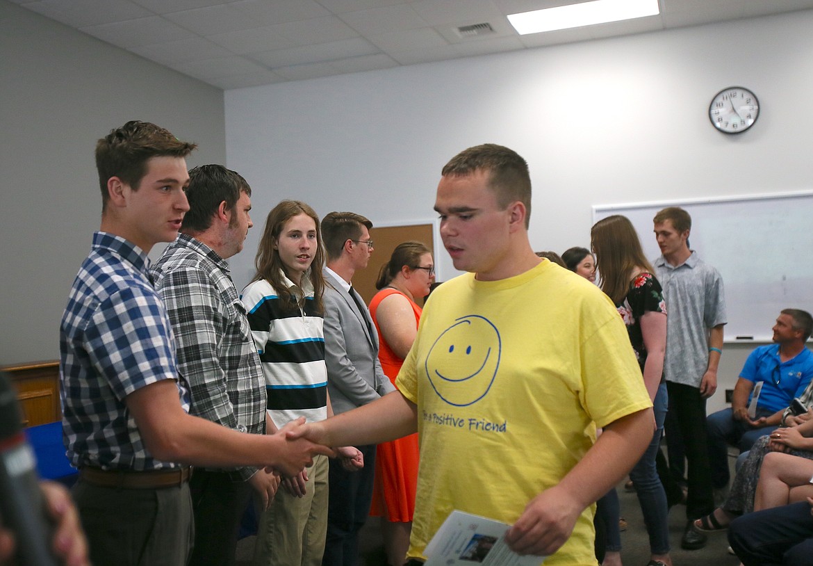 2023 Project SEARCH graduate Ricky Starr, left, welcomes incoming Project SEARCH intern Kaden Peterson at the end of the commencement ceremony Wednesday in Coeur d'Alene. Eight interns graduated from the high school transition program this year, five of whom have already been hired by local companies.