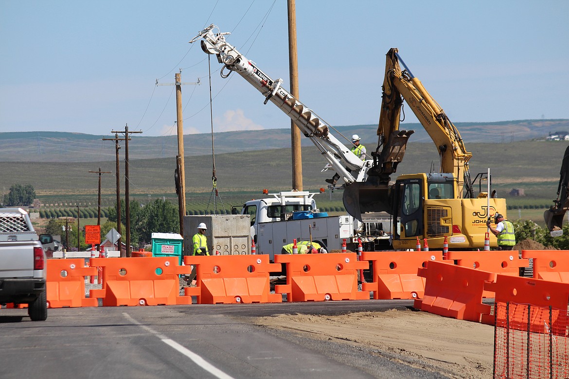 Construction crews work on the roundabout at State Route 28 and White Trail Road in mid-May. The roundabout tentatively is scheduled to open to traffic next week.