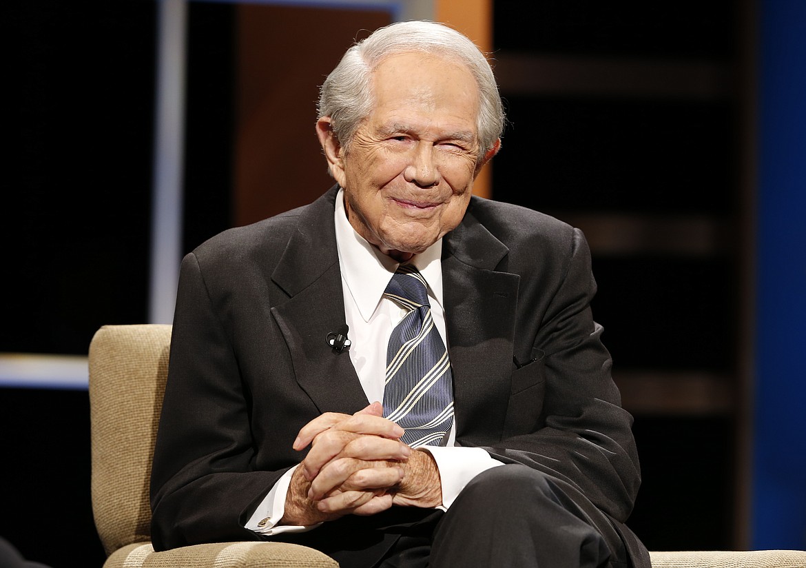 Rev. Pat Robertson poses a question to a Republican presidential candidate during a forum at Regent University in Virginia Beach, Va., Oct. 23, 2015. Robertson, a religious broadcaster who turned a tiny Virginia station into the global Christian Broadcasting Network, tried a run for president and helped make religion central to Republican Party politics in America through his Christian Coalition, has died. He was 93. Robertson's death Thursday, June 8, 2023 was announced by his broadcasting network. (AP Photo/Steve Helber, File)