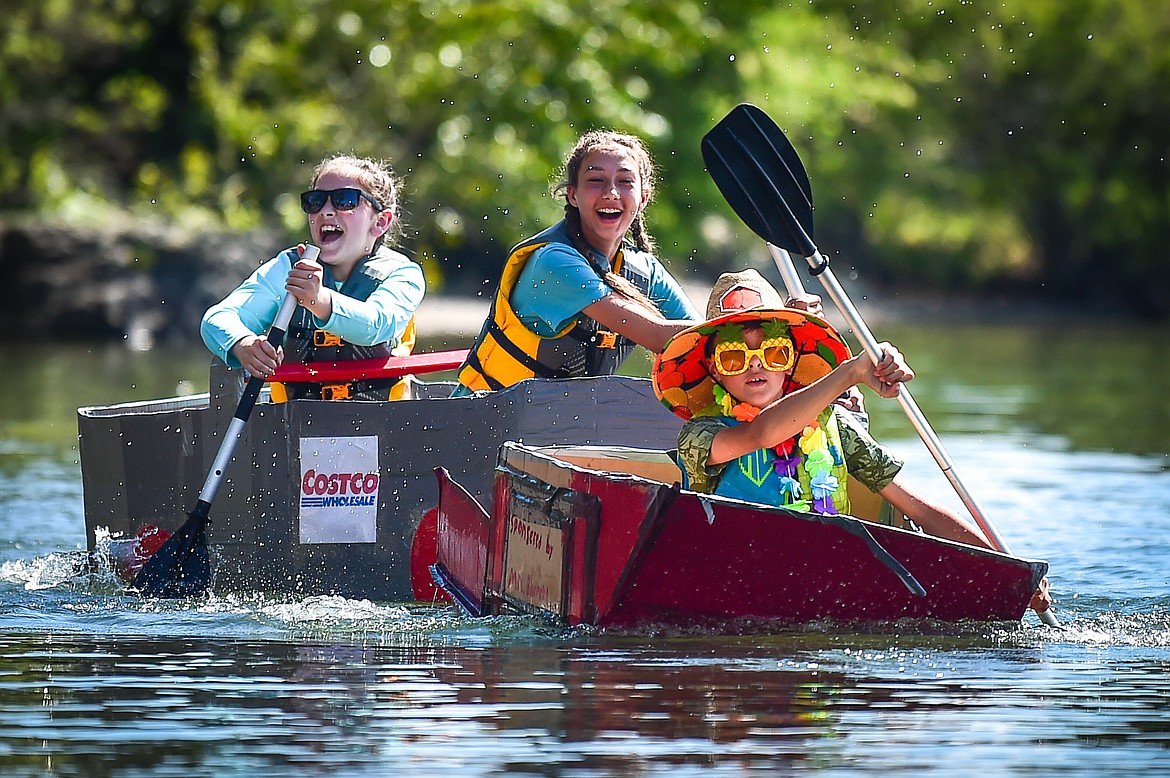 Somers Middle School sixth-graders Cooper Barrett, front, of the Bougie Bandits team, and Izzie Killduff and Kadence Corrigan, of the Costco Karens team, race their cardboard boats in Somers Bay on Thursday, June 8. Fallon Cassidy, Carter Messer and Parker Bradley were also members of the Bandits while Hayley Boggs and Hadley McDonald filled out the Costco Karens team. (Casey Kreider/Daily Inter Lake)