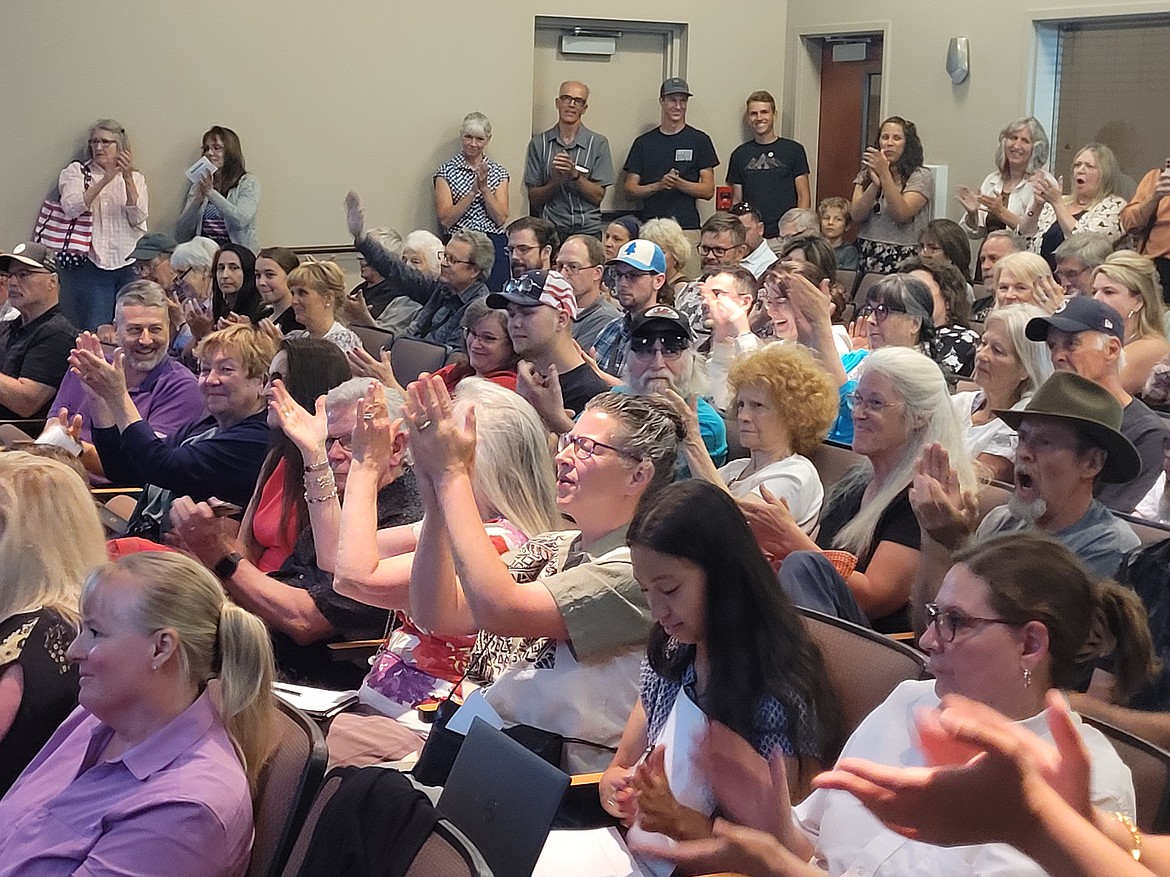 Attendees applaud a speaker in opposition of a regional traffic management center Thursday afternoon during the public comment portion of a Kootenai Metropolitan Planning Organization board meeting at Post Falls City Hall.