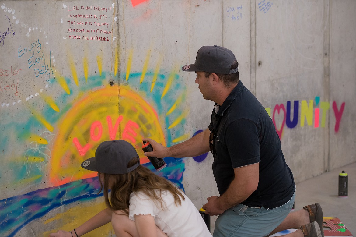 A father and daughter provide some support for the patients who will be using the new Confluence Health radiation treatment center in Moses Lake. The messages will be covered, but participants said the sentiment will still be there.