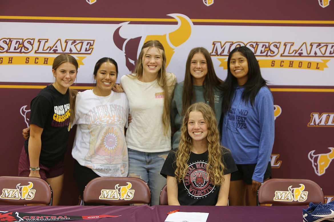 Moses Lake senior Camryn Holterhoff, front row, smiles for photos during Thursday’s signing ceremony in Moses Lake.