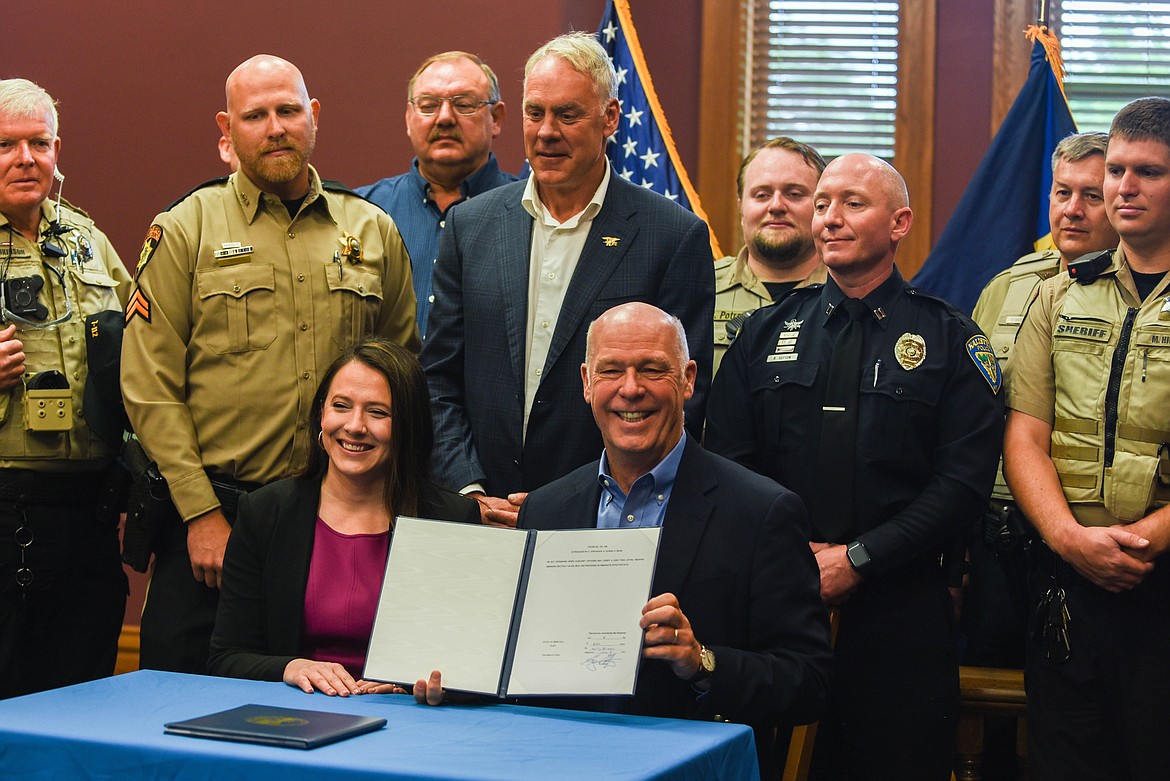 Gov. Greg Gianforte holds up a bill he signed with Rep. Courtney Sprunger, R-Kalispell, on June 9, 2023 at the Flathead County Courthouse during a ceremony. (Kate Heston/Daily Inter Lake)