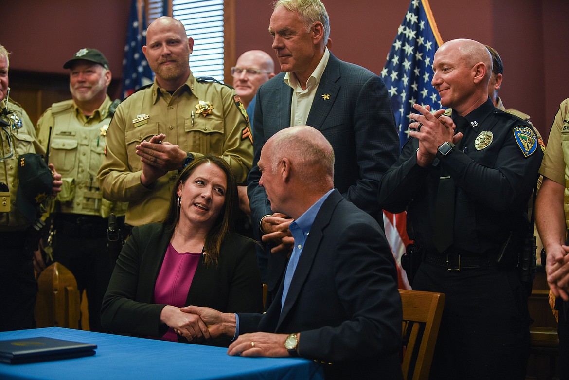 Rep. Courtenay Sprunger, R-Kalispell, shakes hands with Gov. Greg Gianforte at a bill signing ceremony at the Flathead County Courthouse on June 9, 2023. (Kate Heston/Daily Inter Lake)