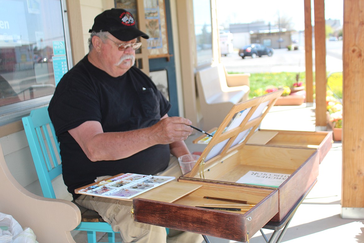 Othello artist Duke Stoker puts brush to paper. Stoker built what he calls the portable artist studio so he can take his watercolor materials on the road.