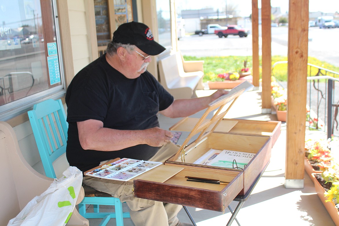 Duke Stoker sets up his portable artist studio. A cabinetmaker as well as a painter, Stoker built it himself.