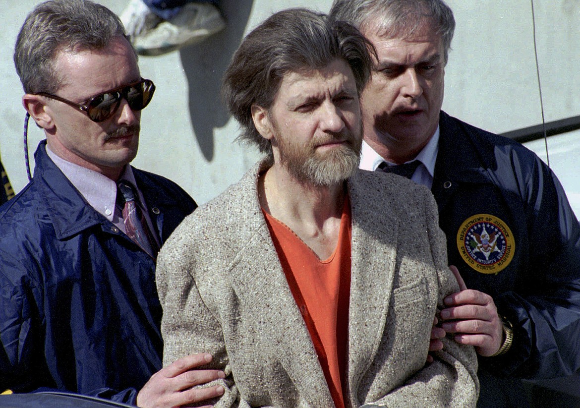 Theodore "Ted" Kaczynski is flanked by federal agents as he is led to a car from the federal courthouse in Helena, Mont., April 4, 1996. A spokesperson for the Bureau of Prisons on Saturday, June 10, 2023, told The Associated Press that Kaczynski, known as the “Unabomber,” has died in federal prison. The cause of death was not immediately known. (AP Photo/John Youngbear, File)