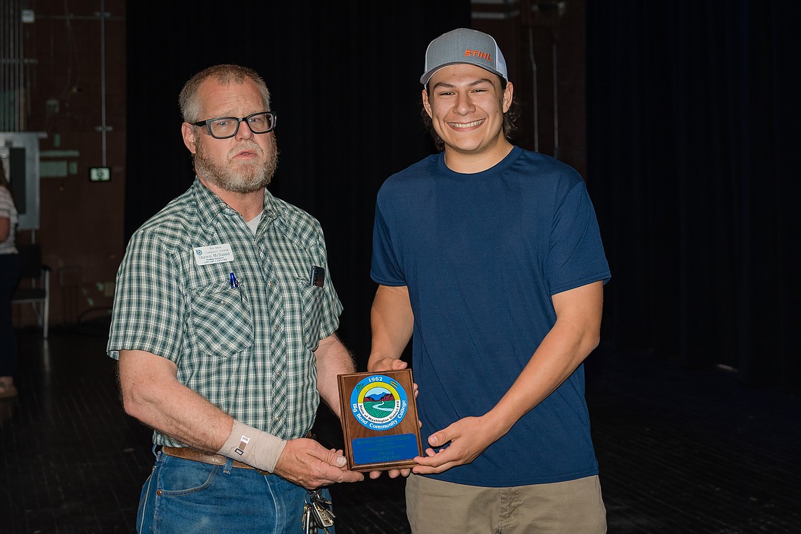 Big Bend Community College welding instructor Shawn McDaniel, left, and welding student Zion Figueroa display the Outstanding Student Award Figueroa received Thursday.