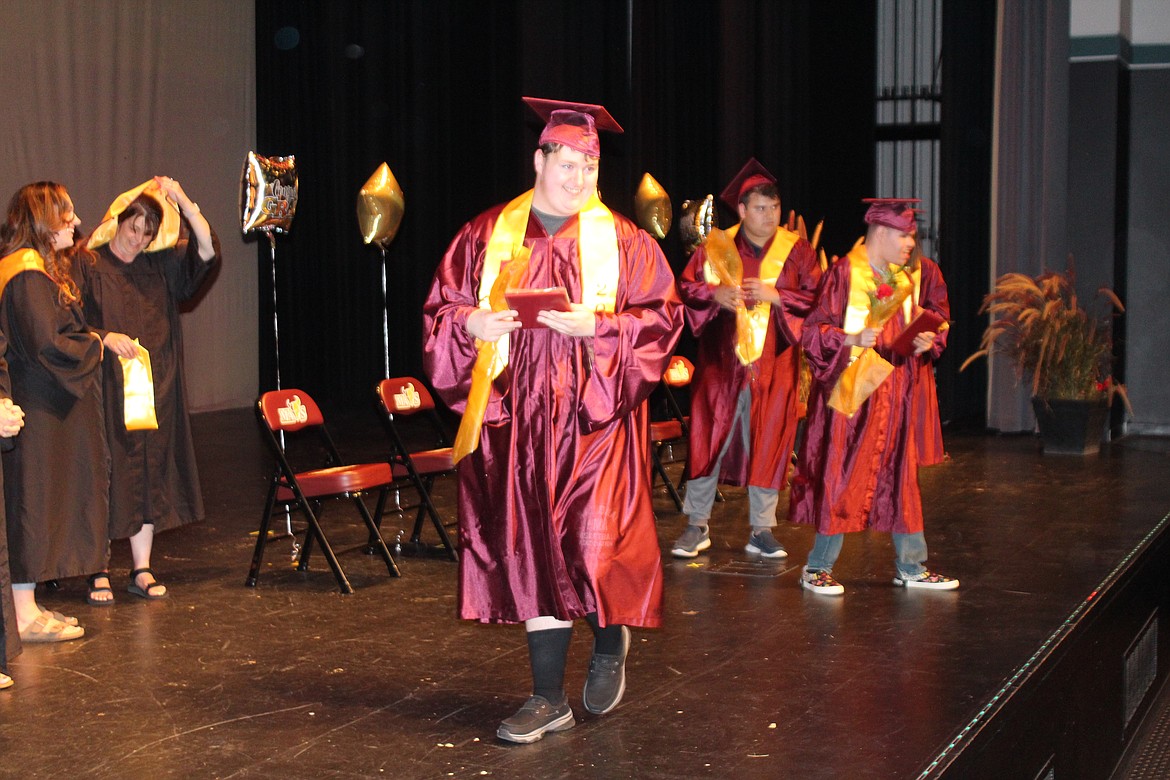 Students in the PALS (Life Skills) class at Moses Lake High School cross the stage after receiving their diplomas June 7.