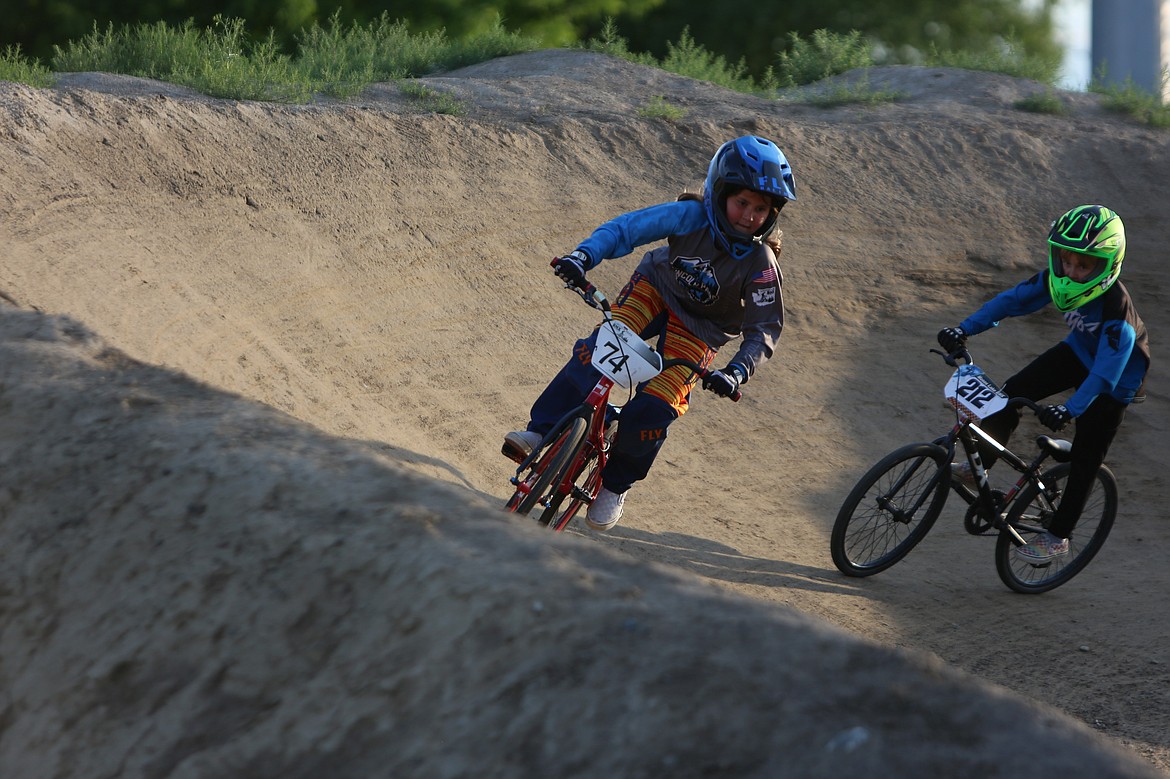 BMX riders maneuver through the third corner of the Larson BMX Track at Friday night’s Local Single Point Race.