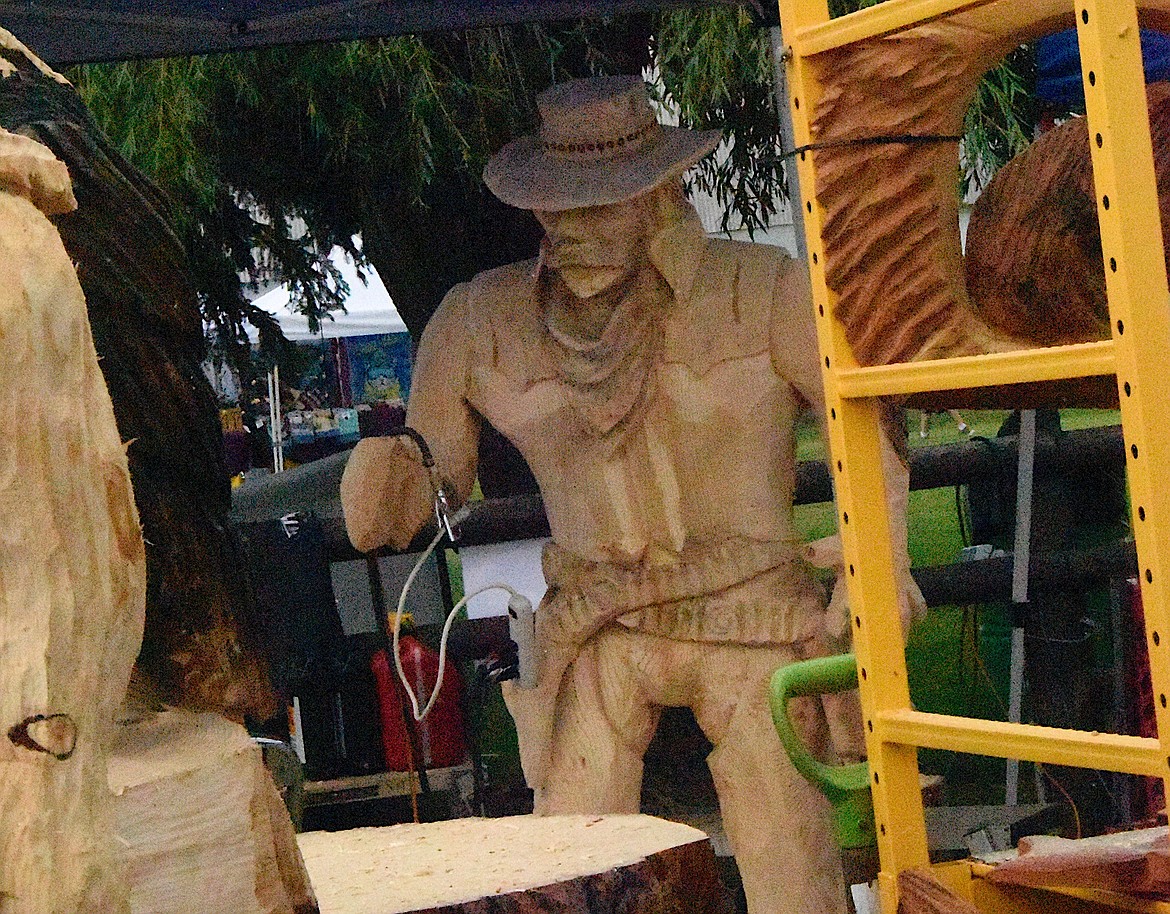 Chainsaw carver Anthony Robinson, Hoquiam, Wash., created this more-than-life-size gunslinger for the Sunday auction at the 2023 Chainsaw Carving Rendezous in Ronan. (Berl Tiskus/Leader)