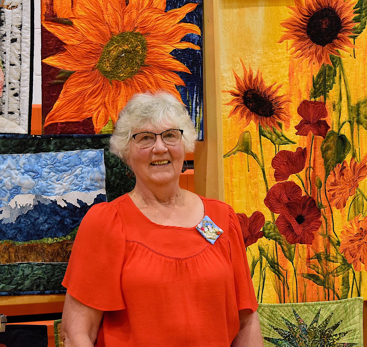 Evelyn Kelch is surrounded by quilted items she made and loves. Kelch was one of two featured quilters at the Mission Mountain Quilt Guild's 30th Annual Quilt Show. The show was held in conjunction with the Chainsaw Carver's Rendezvous in Ronan. (Berl Tiskus/Leader)