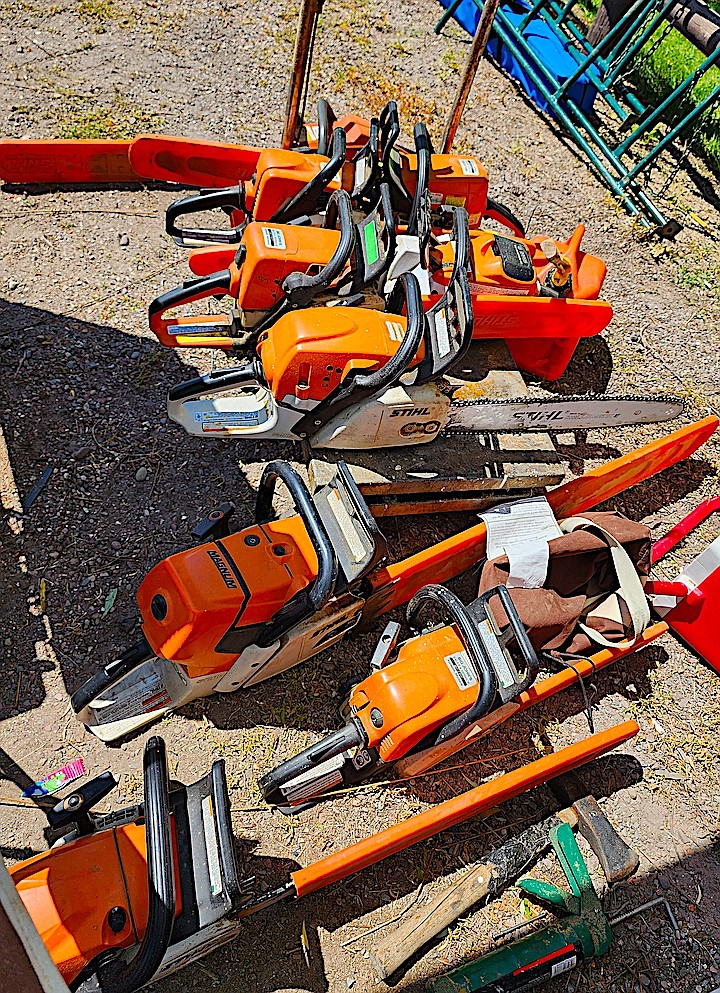 Chainsaw carver Todd Coats has a sizable stable of chain saws to help with the big cuts, rough cuts, and detail work. (Berl Tiskus/Leader)