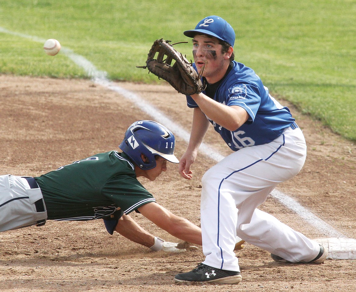 Mission Mariners' Cole Wadsworth is checked by Libby first baseman Chase Rayome on a throw from pitcher Caleb Moeller in the top of second inning in the first game of a doubleheader on Saturday, June 10. The Mariners won, 4-2. (Paul Sievers/The Western News)