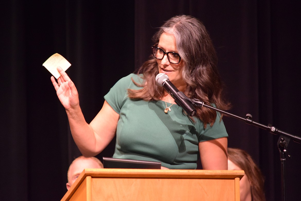 Almira Coulee Hartline School District Superintendent and ACH High School Principal Kelley Boyd holds up a sticky note upon which she wrote a song title. Boyd wrote out 15 titles on 15 sticky notes and put one in each diploma for the school’s graduating seniors June 10.