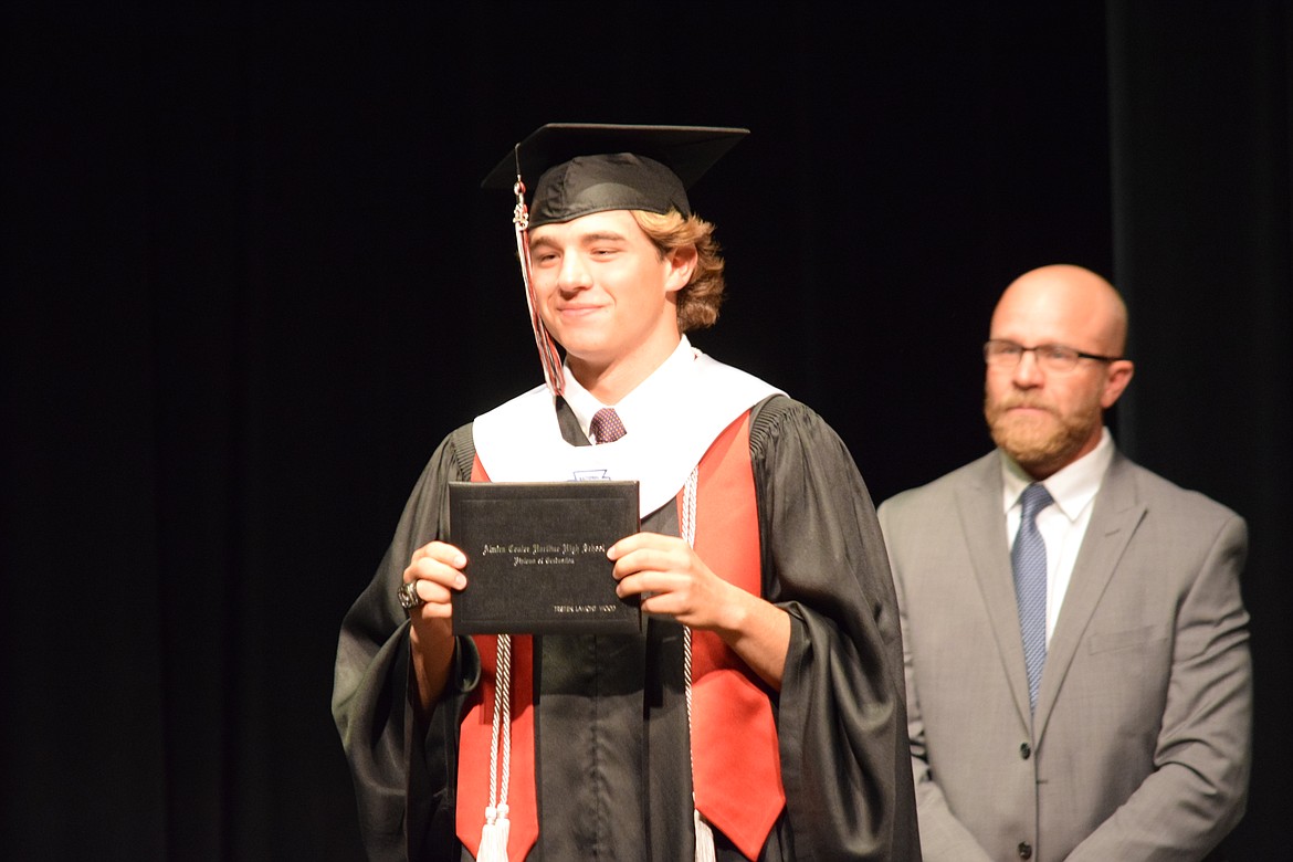 ACH High School graduate Tristen Wood holds up his diploma after receiving it during the school’s 2023 graduation ceremony on June 10.