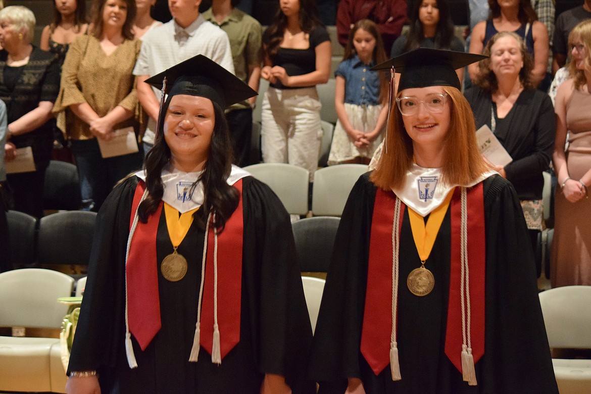 ACH High School co-valedictorians Isabel Brink, left, and Kaylee Wodtka, right, process into the gymnasium at the start of the school’s graduation ceremony on June 10.