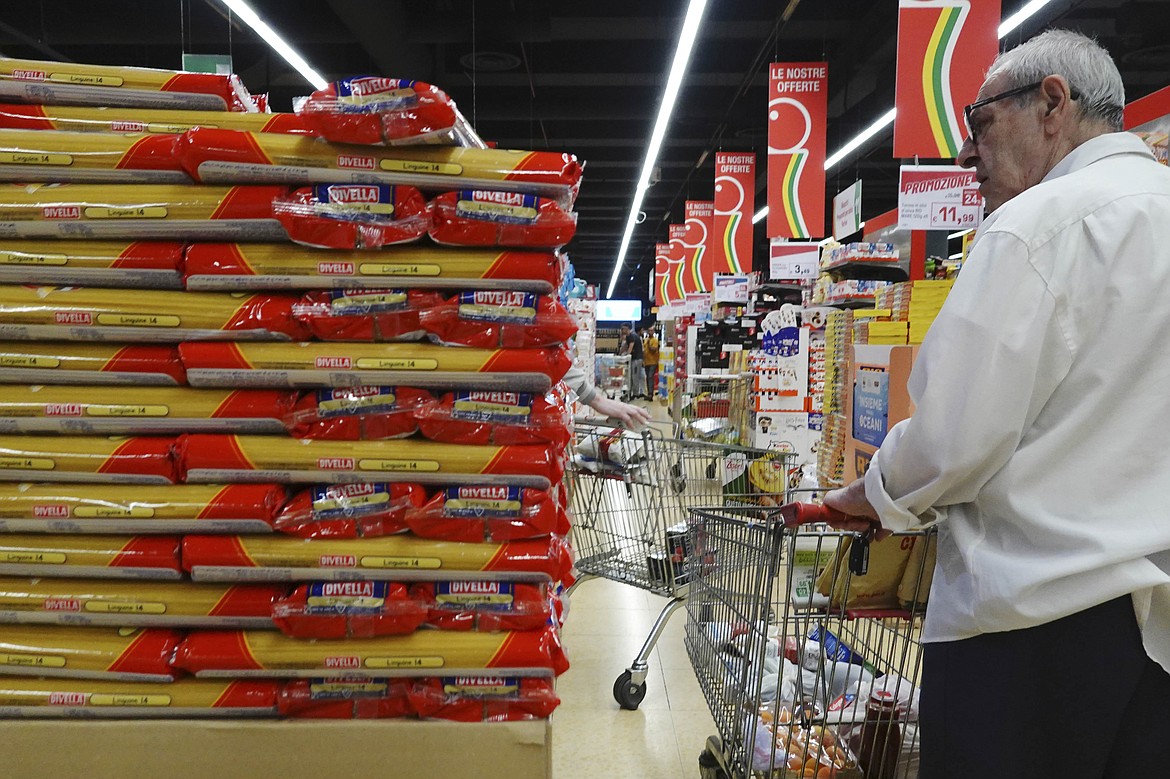 Customers look at packages of pasta on sale in a supermarket in Milan, northern Italy, Thursday, June 8, 2023. Italians are calling for a pasta protest as food prices squeeze Europe. Grocery prices have risen more sharply in Europe than in other advanced economies from the U.S. to Japan, driven by higher energy and labor costs and the impact of Russia's war in Ukraine. (AP Photo/Luca Bruno)