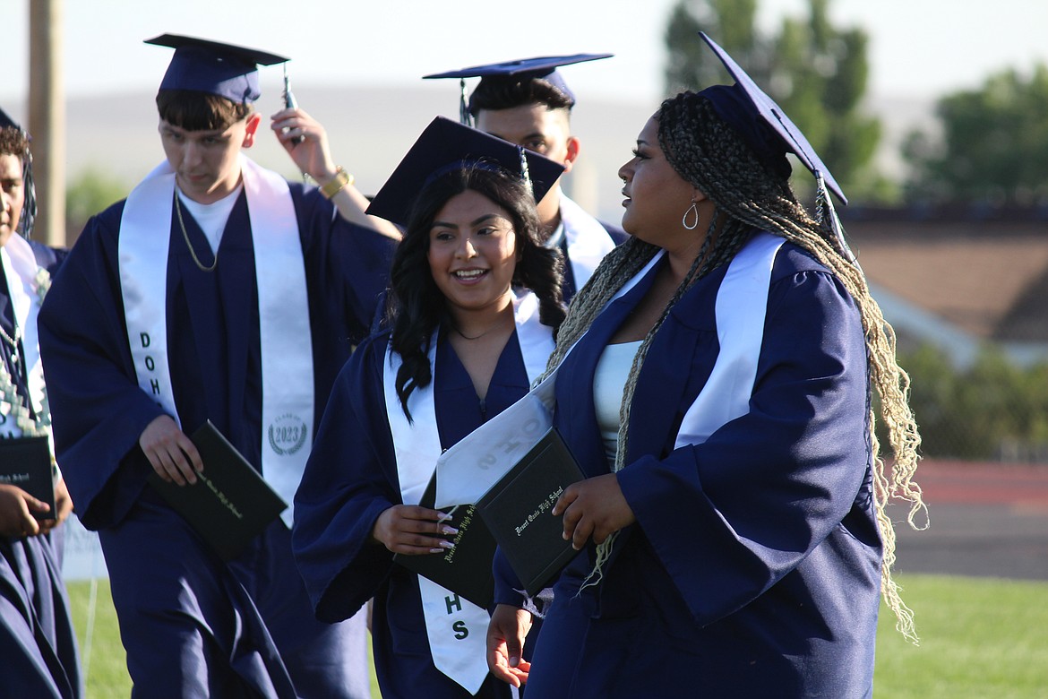 Brand new Desert Oasis High School graduates leave Huskie Stadium after graduation.