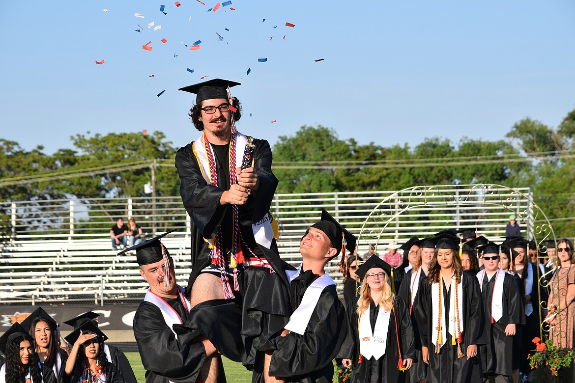 An Ephrata High School senior twists a compressed air party popper during the processional at the 2023 Ephrata High School Graduation June 2.