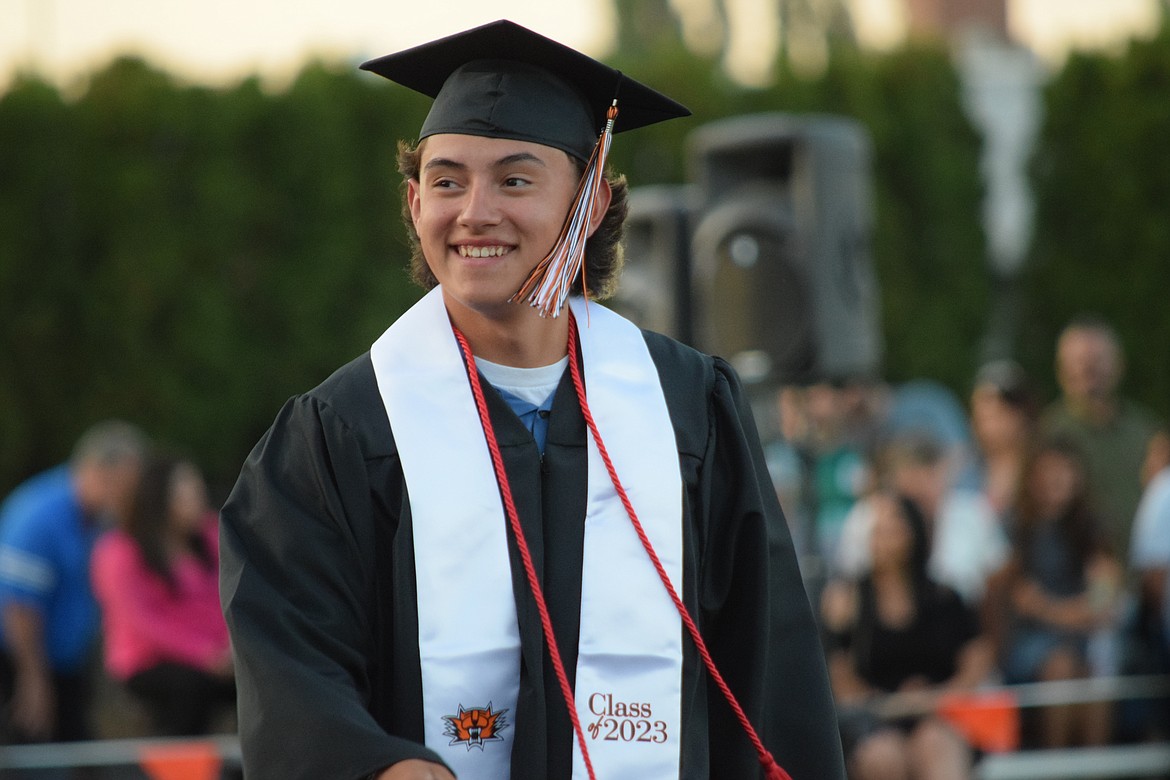 A graduating senior prepares to receive his diploma.