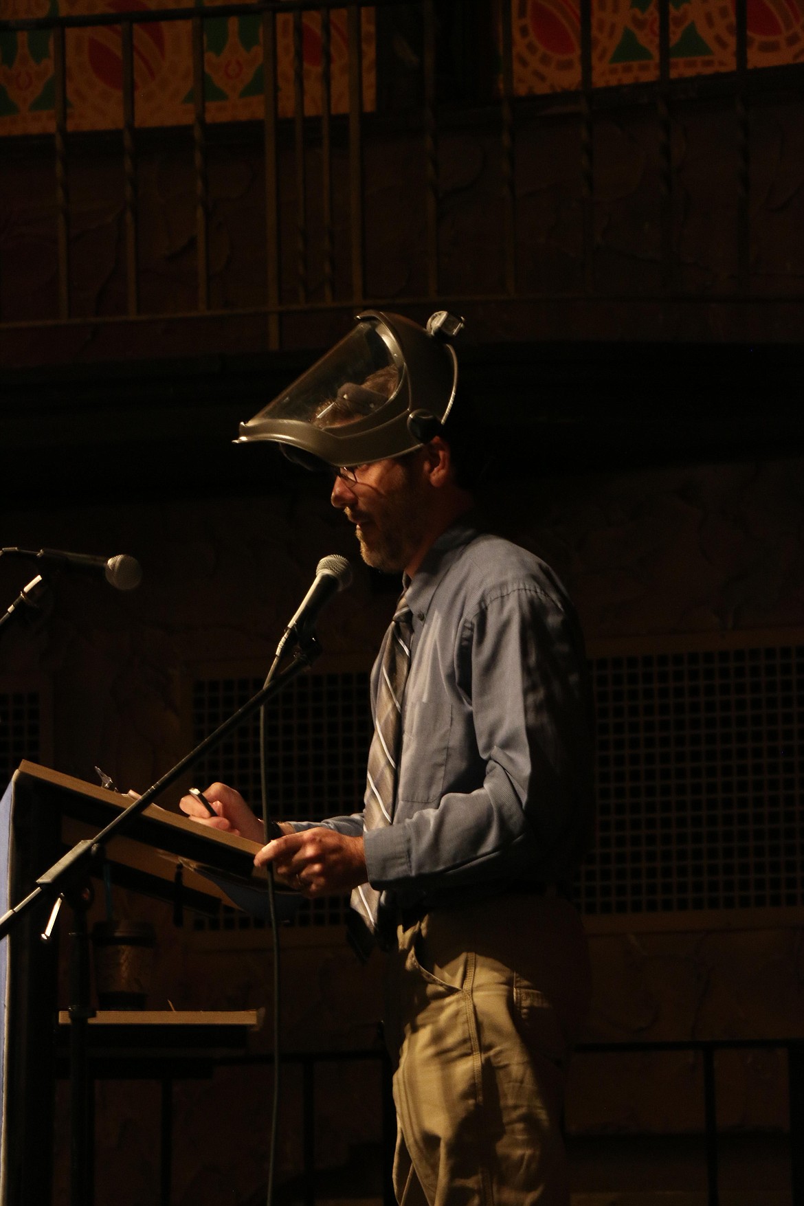 Forrest Bird Charter School teacher Mark Webber puts on his mask to remind the soon-to-be graduates of a moment in class. The moment was one of many during his speech at Saturday's graduation to burst into laughter.