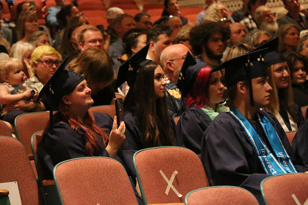 A Forrest Bird Charter School graduate records the ceremony from the comfort of her seat during Saturday's graduation.