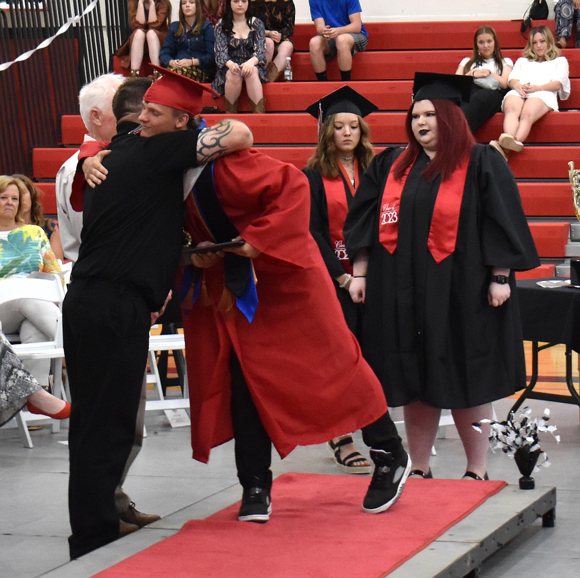 Lind-Ritzville Senior Hayden Melcher hugs Lind School Board Chairman Adams Labes as he receives his diploma June 3.