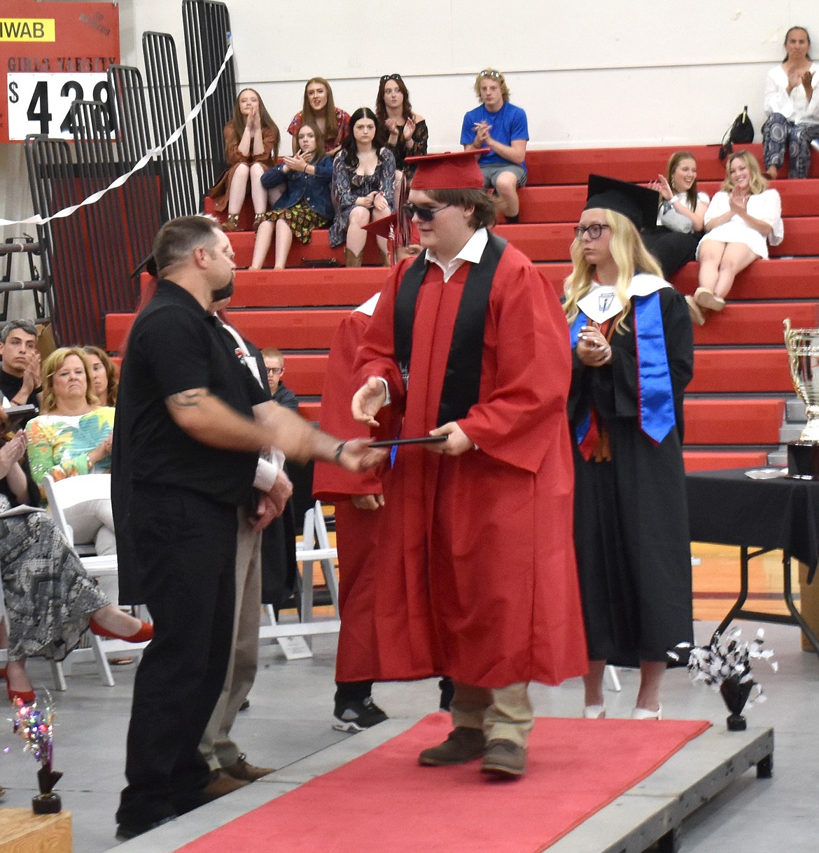 Lind-Ritzville senior Karl Ward receives his diploma from Lind School Board Chairman Adam Labes June 3.