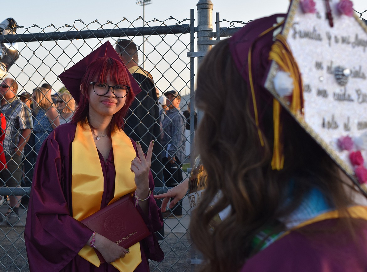 Huỳnh Nữ Long Vân poses for a photo right after exiting Lions Field following the Moses Lake High School graduation. Huỳnh said she is happy to be done with high school but enjoyed time with friends.