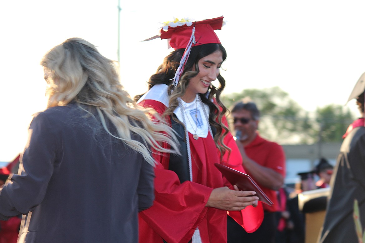 Holding her diploma, an Othello senior leaves the stage.