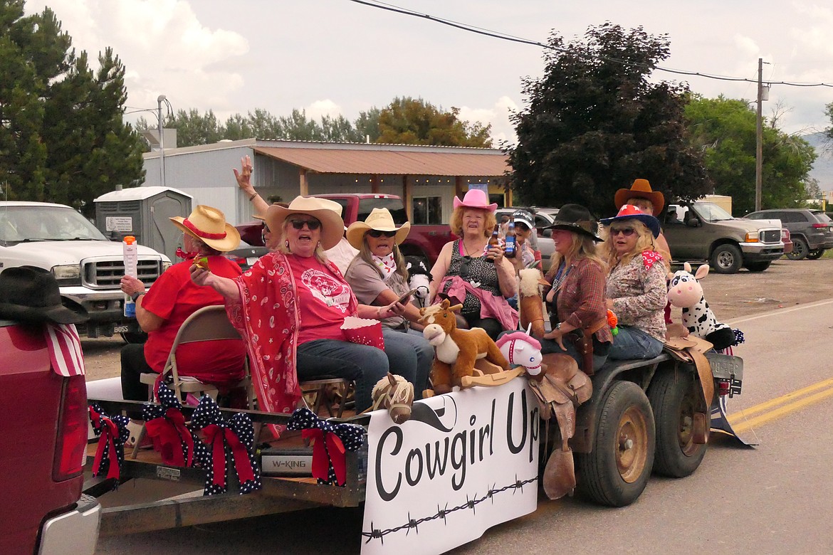 Ladies aboard a Homesteader Days parade float are all smiles as they celebrate their ride through Hot Springs Sunday afternoon.  (Chuck Bandel/VP-MI)