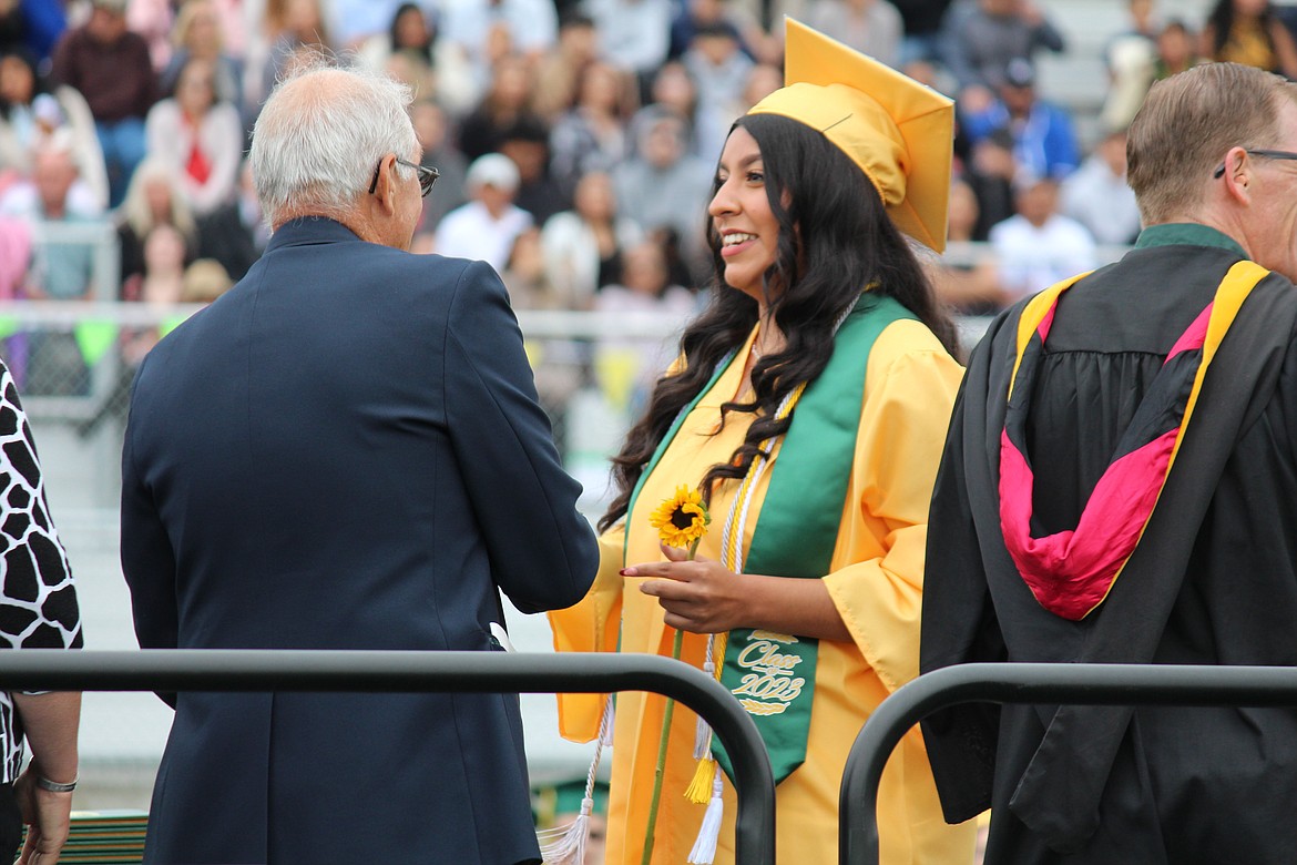 QUINCY — A senior from the Quincy High School class of 2023 receives her diploma from Quincy School Board chair Chris Baumgartner, left. Graduation ceremonies were Saturday.